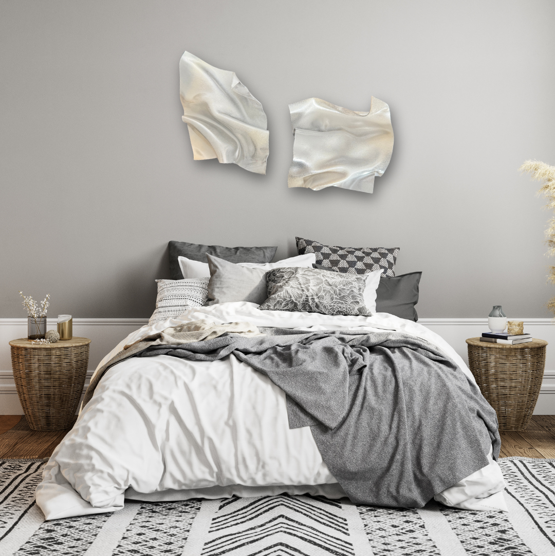 Bedroom with gray walls, a bed with gray and white bedding, and abstract wall art.