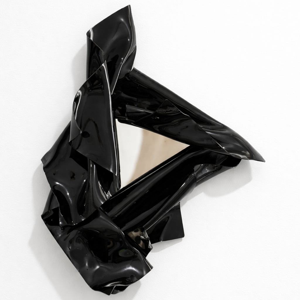 Black abstract sculpture on a white background